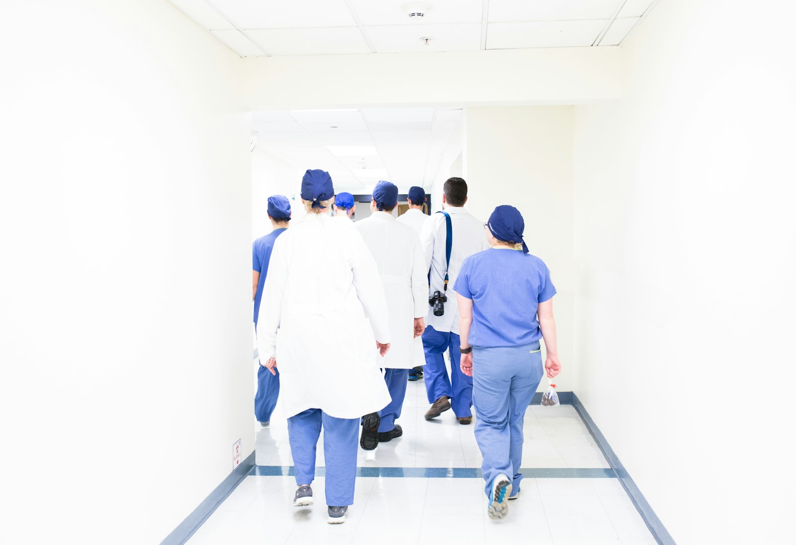 Clinical staff walking together through a hospital corridor